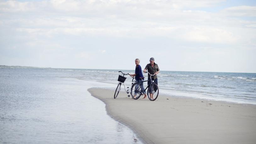 Couple with bike on Fanø beach