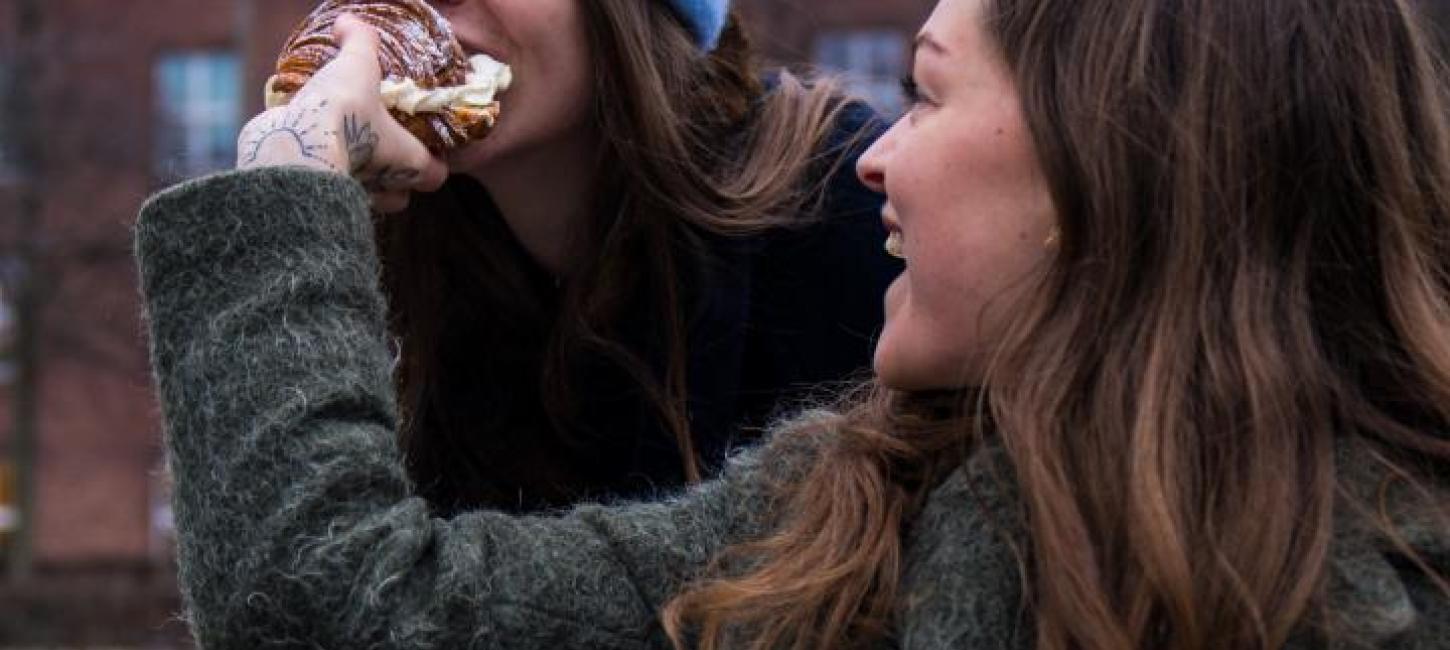 Person biting in Fastelavnsbolle in Copenhagen 