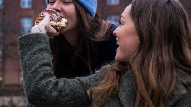 Person biting in Fastelavnsbolle in Copenhagen