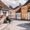 Women sitting on a bench in old town of Odense on Fyn