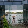 A man swims from the Urban Rigger student housing block designed by Bjarke Ingels Group in Copenhagen, Denmark