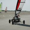 A man sits in a blokart on a beach in Fanø, an island in Denmark