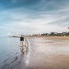 Couple walking along Hjerting Strand, Esbjerg