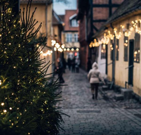 A cobbled street in Odense lit with Christmas lights