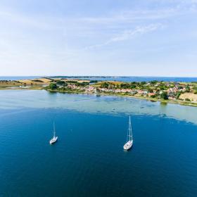 Sailing boats on the blue water around Fyn. 