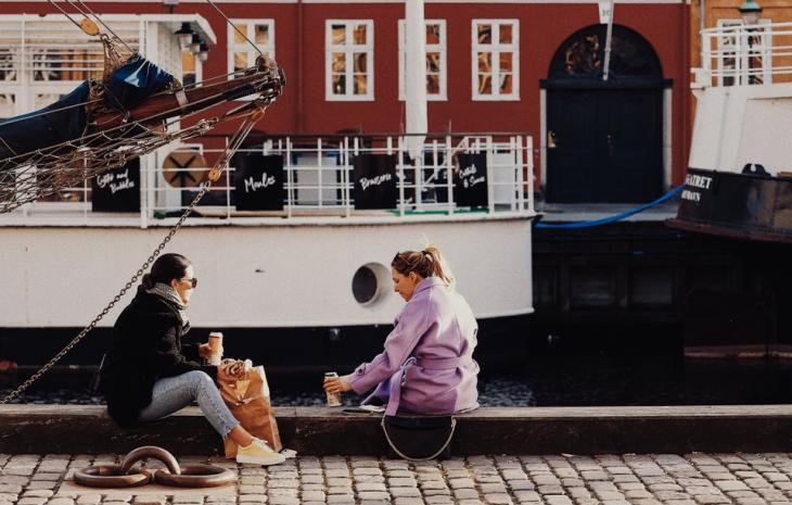 To venniner som tar en kaffe på Nyhavn i København